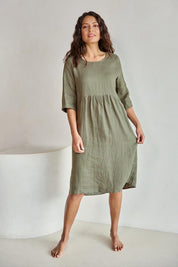 Model Tahneei wearing size 10 of the Linen Pocket Dress – Olive in colour Olive, from the front