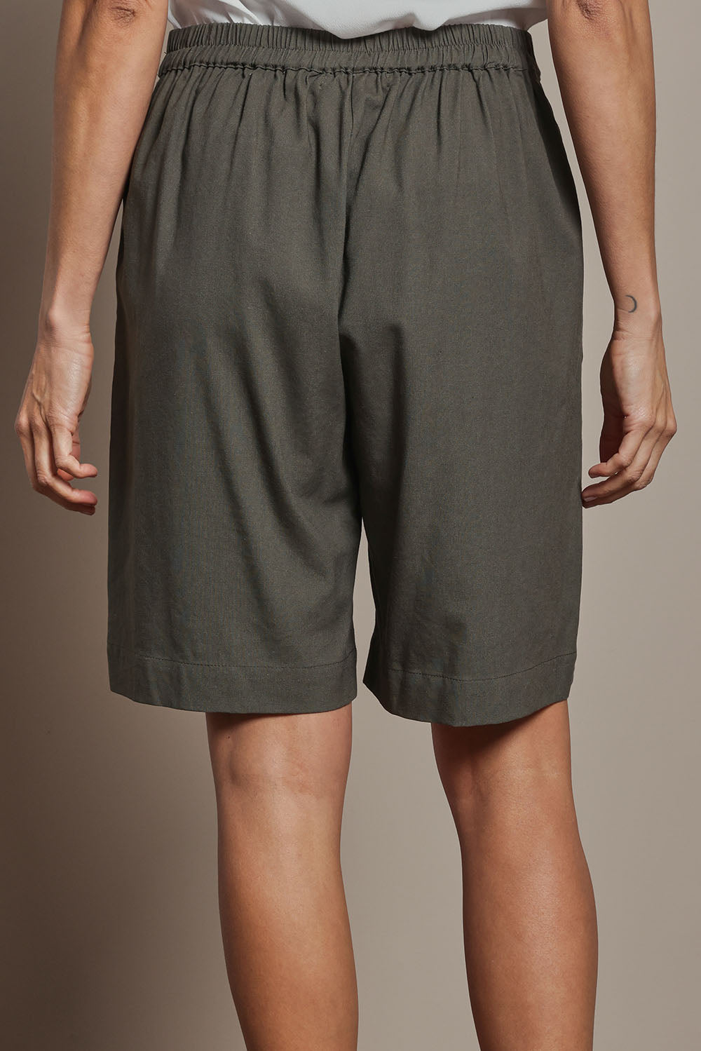 Model Amanda wearing size 10 of the Linen Cotton Pull On Shorts in colour Khaki (Green), from the back
