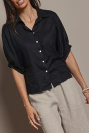 Model Amanda wearing size 10 of the Linen Pleated Sleeve Shirt in colour Black (Black), from the front, cropped image