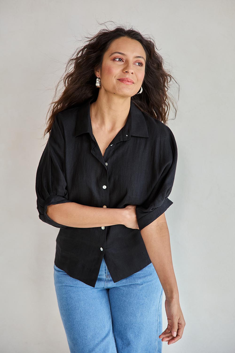 Model Tahneei wearing size 10 of the Linen Pleated Sleeve Shirt – Black in colour Black, in a cropped view