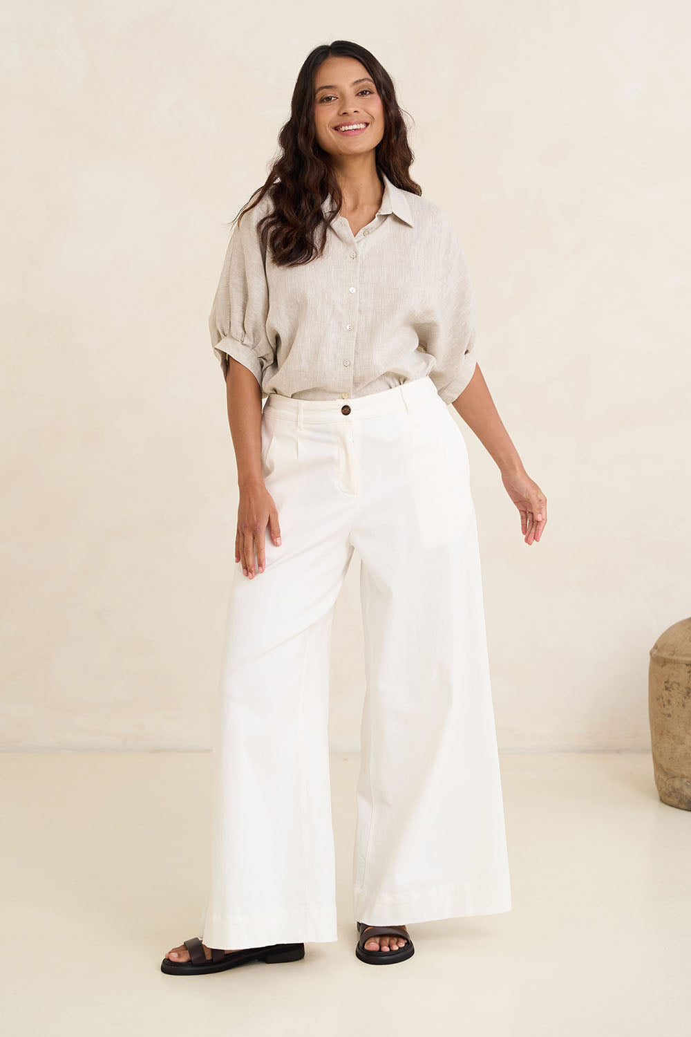 Model Tahnee wearing size 10 of the Linen Pleated Sleeve Shirt in colour Natural, from the front, showing the whole outfit