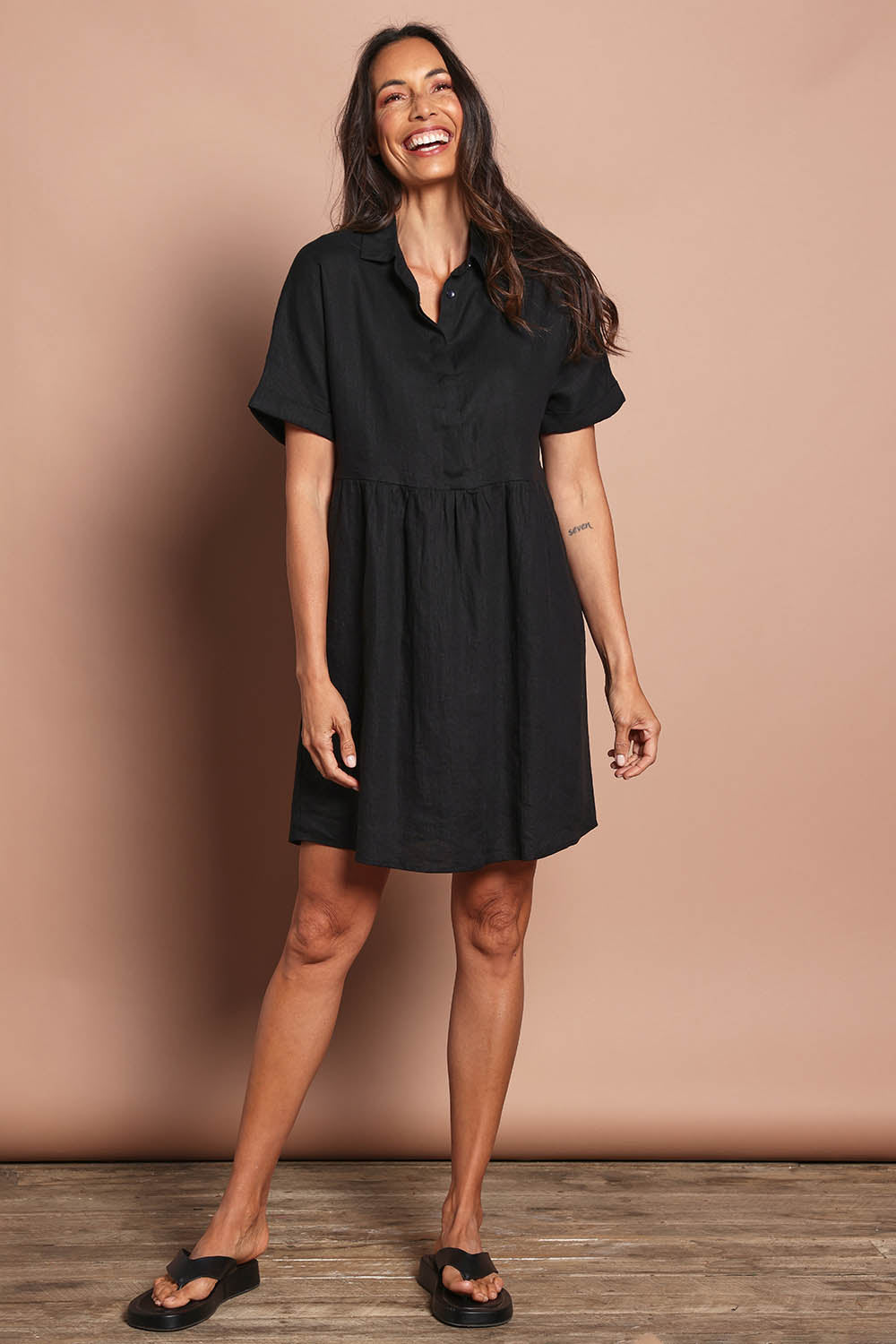 Model Amanda wearing size 10 of the Linen Throw On Dress in colour Black (Black), from the front, showing the whole outfit