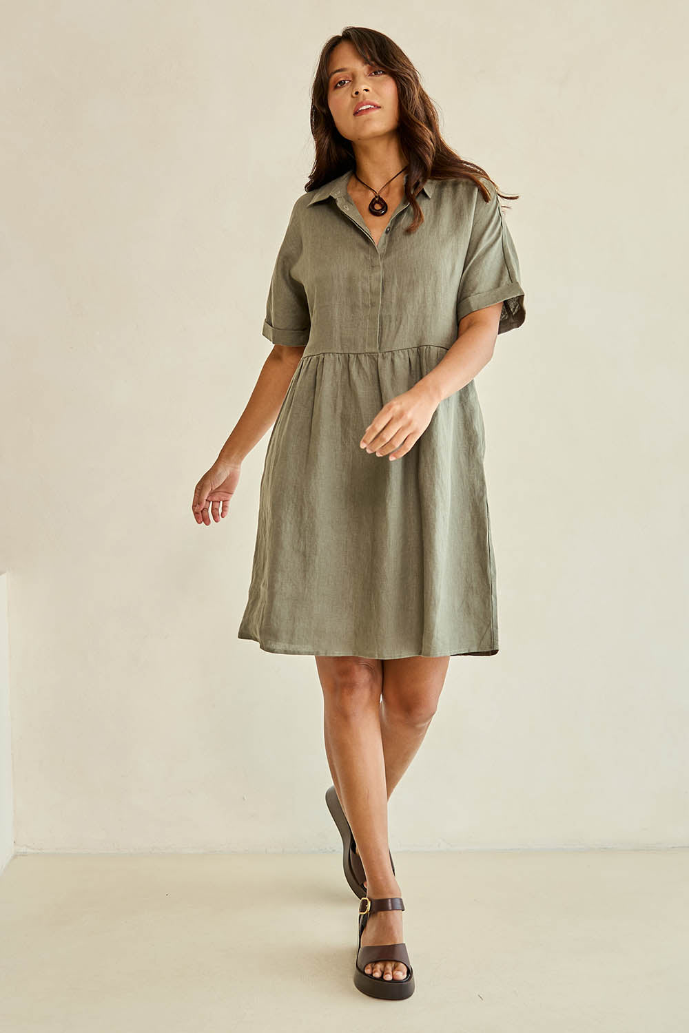 Model Tahnee wearing size 10 of the Linen Throw On Dress in colour Olive (Green), from the front, showing the whole outfit
