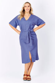 Model Jess wearing size 14 of the Natural Throw Dress in colour Fleet (Blue), from the front, showing the whole outfit