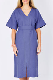 Model Maddy wearing size 10 of the Natural Throw Dress in colour Fleet (Blue), from the front, cropped image