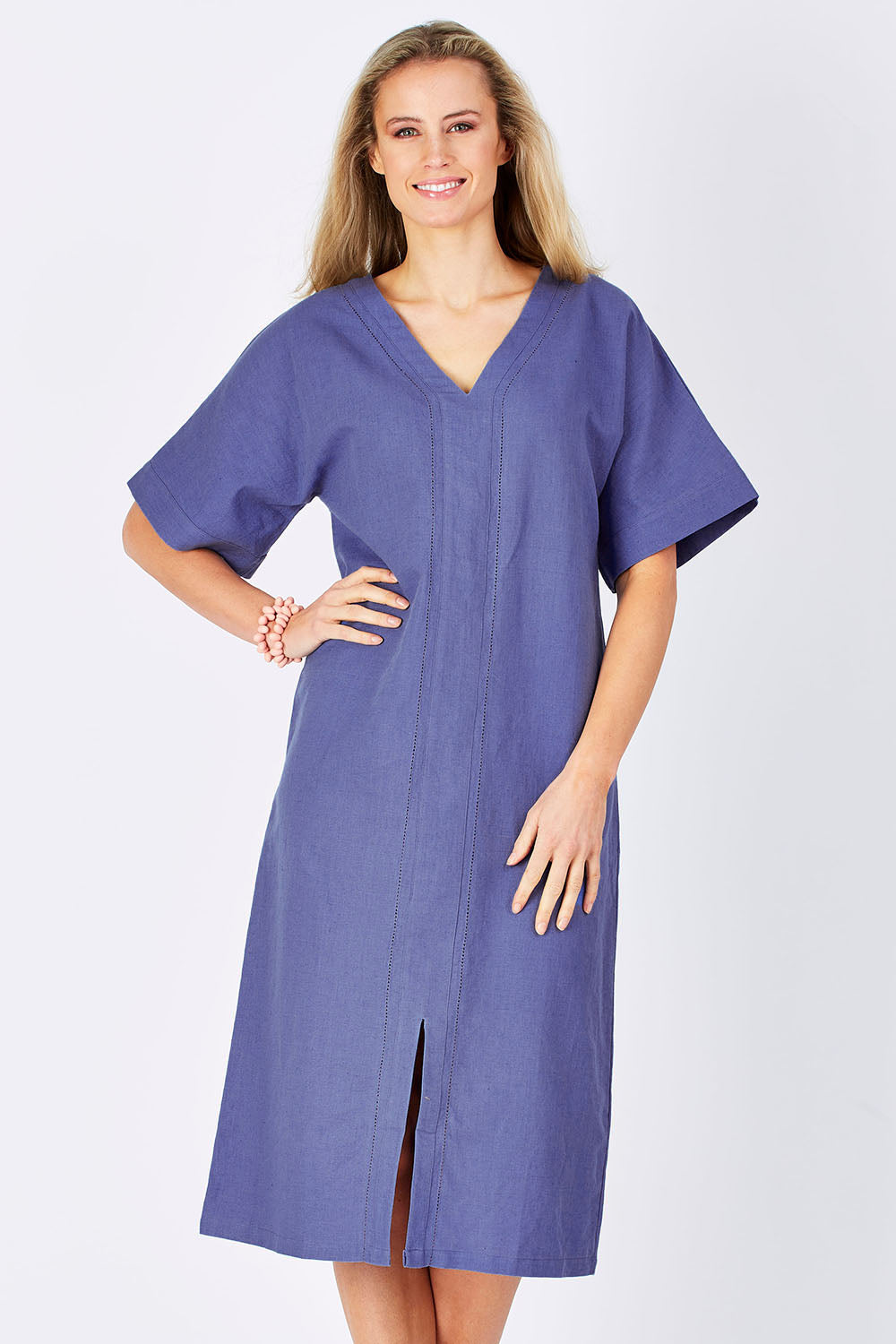 Model Maddy wearing size 10 of the Natural Throw Dress in colour Fleet (Blue), from the front, cropped image