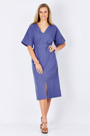 Model Maddy wearing size 10 of the Natural Throw Dress in colour Fleet (Blue), from the front, showing the whole outfit