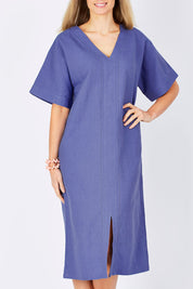 Model Maddy wearing size 10 of the Natural Throw Dress in colour Fleet (Blue), from the front, showing the whole outfit