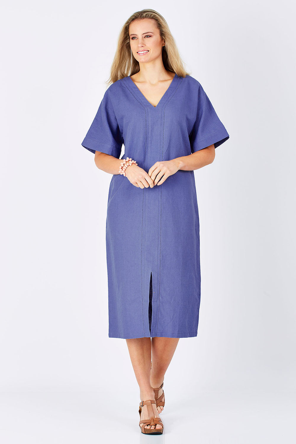 Model Maddy wearing size 10 of the Natural Throw Dress in colour Fleet (Blue), from the front, showing the whole outfit