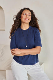 Model Tahneei wearing size 10 of the Linen Lyocell Textured Knit Tee – Blue in colour Blue, in a cropped view