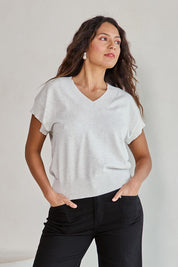 Model Tahneei wearing size 10 of the Cotton Cashmere Relaxed Knit – Dove in colour Dove, from an angle