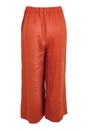 Product shot of the Linen Cropped Drawstring Pant – Rust in colour Rust, from the back