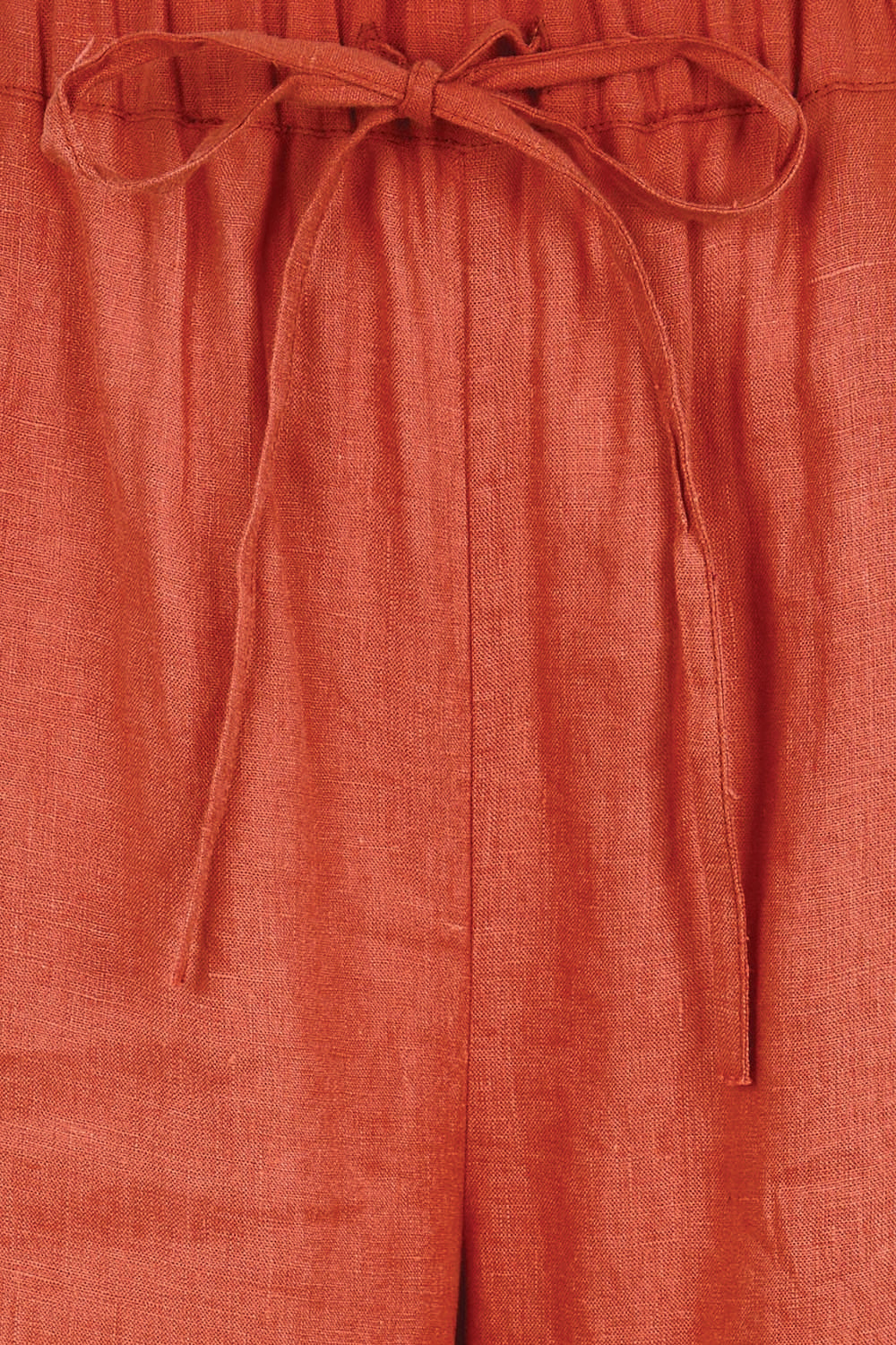 Product shot of the Linen Cropped Drawstring Pant – Rust in colour Rust, showing detail
