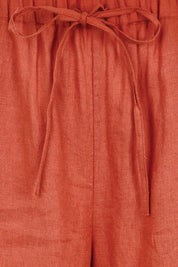 Product shot of the Linen Cropped Drawstring Pant – Rust in colour Rust, showing detail