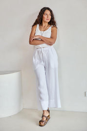 Model Tahneei wearing size 10 of the Linen Cropped Drawstring Pant – White in colour White, from the front