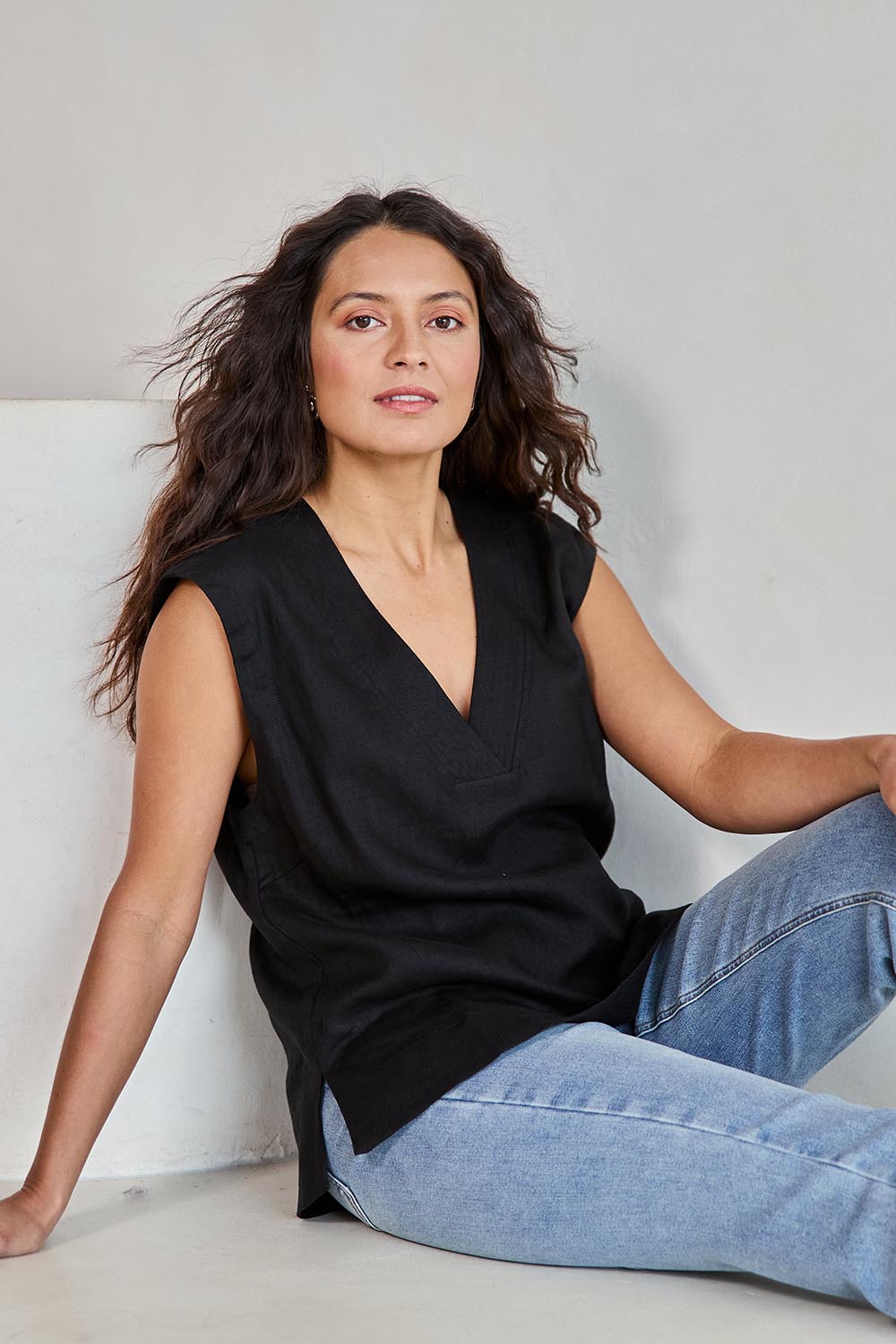Model Tahneei wearing size 10 of the Linen V Neck Tank – Black in colour Black, in a cropped view