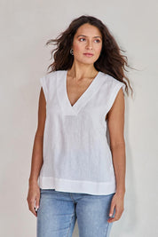 Model Tahneei wearing size 10 of the Linen V Neck Tank – White in colour White, in a cropped view