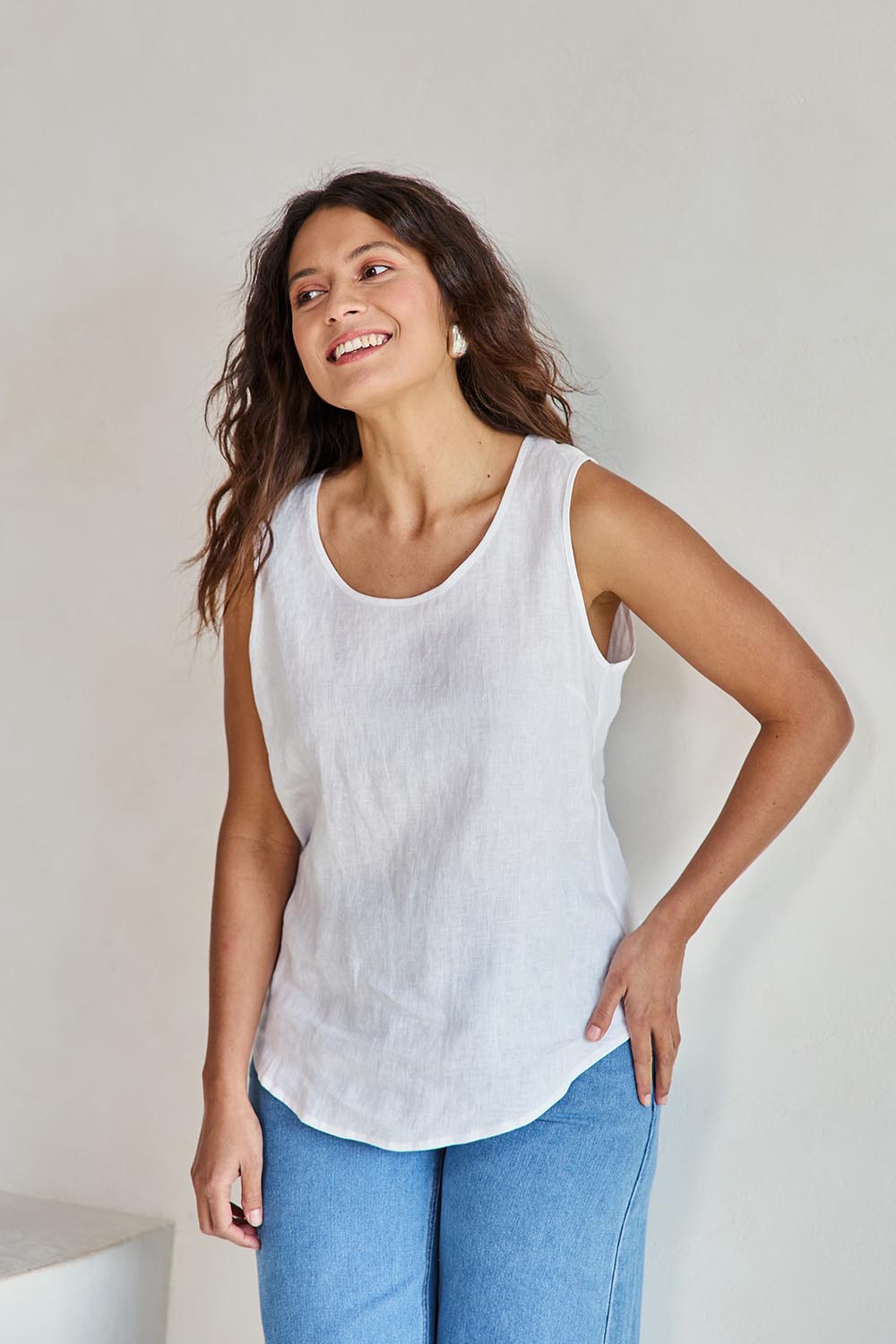 Model Tahneei wearing size 10 of the Linen Tank – White in colour White, from an angle