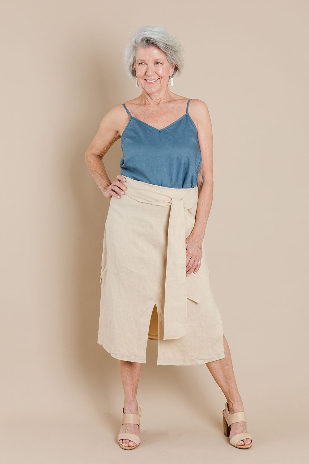 Model Elise wearing size 10 of the Cotton Linen Waist Tie Skirt in colour Macadamia, from the front, showing the whole outfit