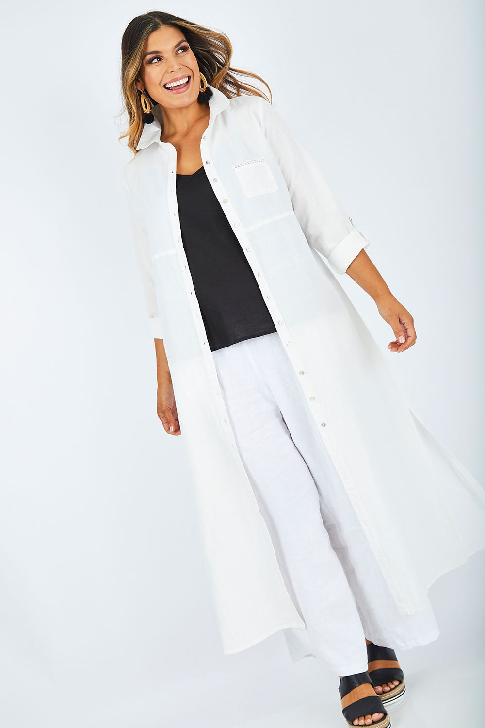 Model Palatina wearing size 14 of the Cotton Linen Longline Shirt in colour Coconut (White), from the front, showing the whole outfit