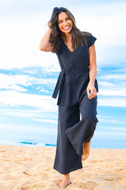 Model Amanda wearing size 10 of the Linen Blend Jumpsuit in colour Raven (Blue), from the front, showing the whole outfit