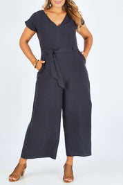 Model Palatina wearing size 14 of the Linen Blend Jumpsuit in colour Raven (Blue), from the front, cropped image