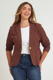 Model Chanel wearing size 16 of the Cotton Linen Blazer in colour Chocolate, from the front, cropped image