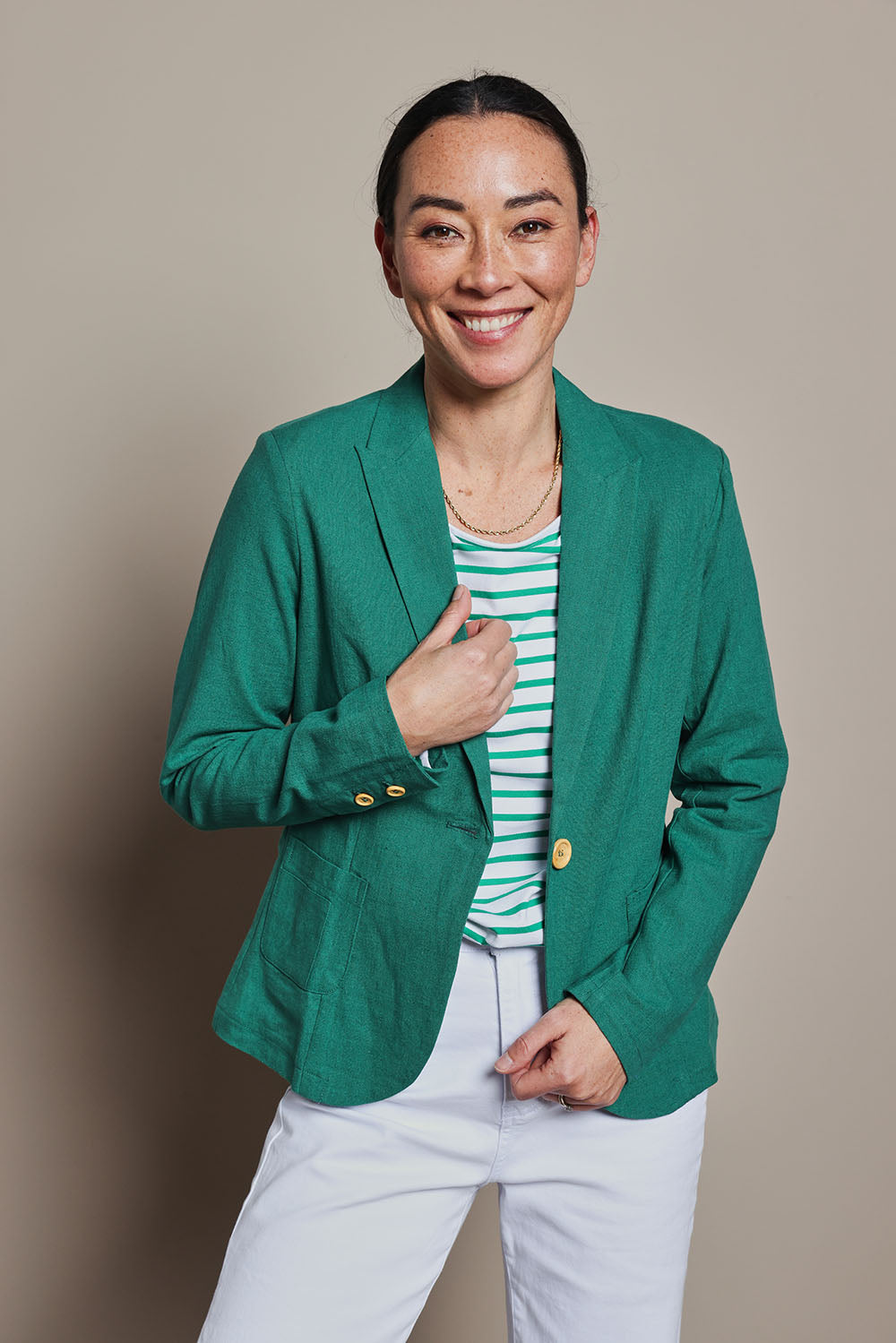 Model Katie wearing size 8 of the Cotton Linen Blazer in colour Green (Green), from the front, cropped image