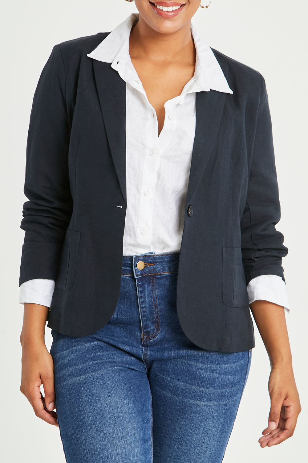 Model Noli wearing size 14 of the Cotton Linen Blazer in colour Midnight (Black), from the front, cropped image