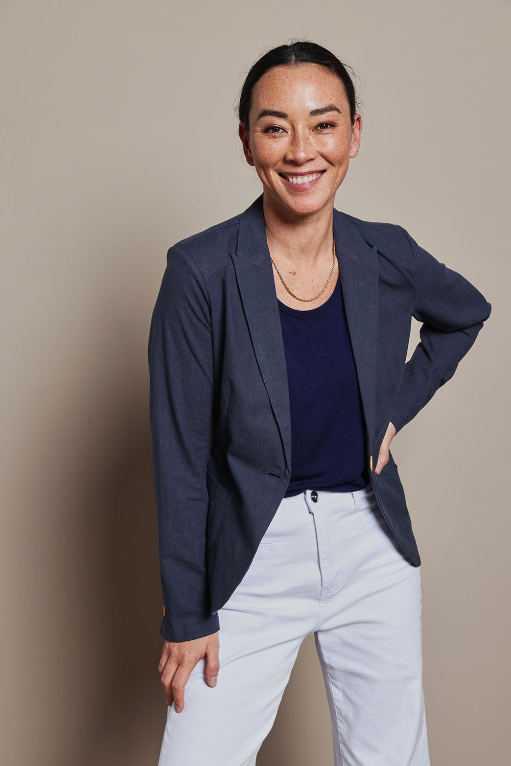 Model Katie wearing size 8 of the Cotton Linen Blazer in colour Navy (Blue), from the front, cropped image