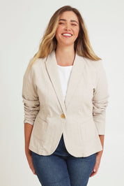 Model Chanel wearing size 16 of the Cotton Linen Blazer in colour Sand, from the front, cropped image