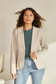 Model Tahneei wearing size 10 of the Cotton Linen Blazer - Sand in colour Sand, in a cropped view