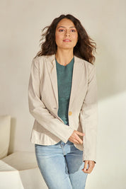 Model Tahneei wearing size 10 of the Cotton Linen Blazer - Sand in colour Sand, in a cropped view