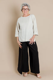 Model Elise wearing size 10 of the Linen Blend Crossover Pants in colour Ebony (Black), from the front, showing the whole outfit