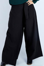 Model Laura wearing size 14 of the Linen Blend Crossover Pants in colour Ebony (Black), from the front, cropped image