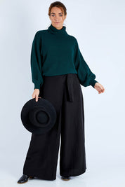 Model Laura wearing size 14 of the Linen Blend Crossover Pants in colour Ebony (Black), from the front, showing the whole outfit