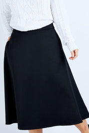 Model Laura wearing size 14 of the Wool Ain colourline Skirt - Midnight (Black), from the front, cropped image