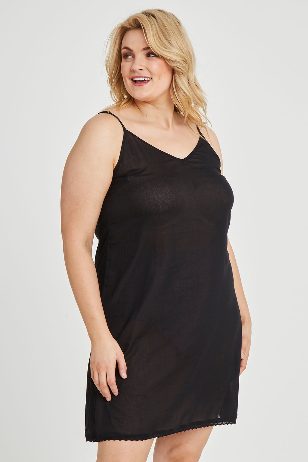 Model Keeara wearing size 16 of the Cotton Slip in colour Black (Black), from the front, cropped image