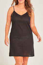 Model Laura wearing size 14 of the Cotton Slip in colour Black (Black), from the front, cropped image