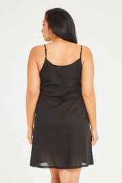 Model Terri-Leigh wearing size 14 of the Cotton Slip in colour Black (Black), from the back