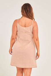 Model Laura wearing size 14 of the Cotton Slip in colour Sand, from the back