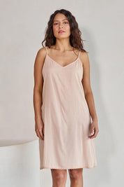 Model Tahneei wearing size 10 of the Cotton Slip - Sand in colour Sand, in a cropped view