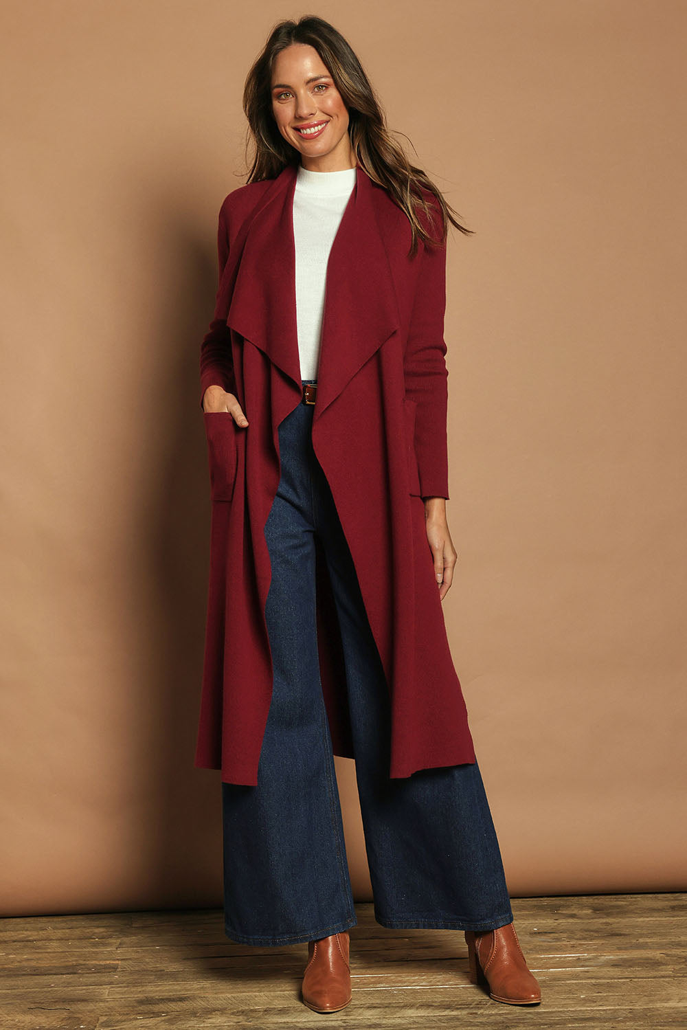Model Madeline wearing size S of the Cotton Cashmere Waterfall Cardigan in colour Berry (Red), from the front, showing the whole outfit
