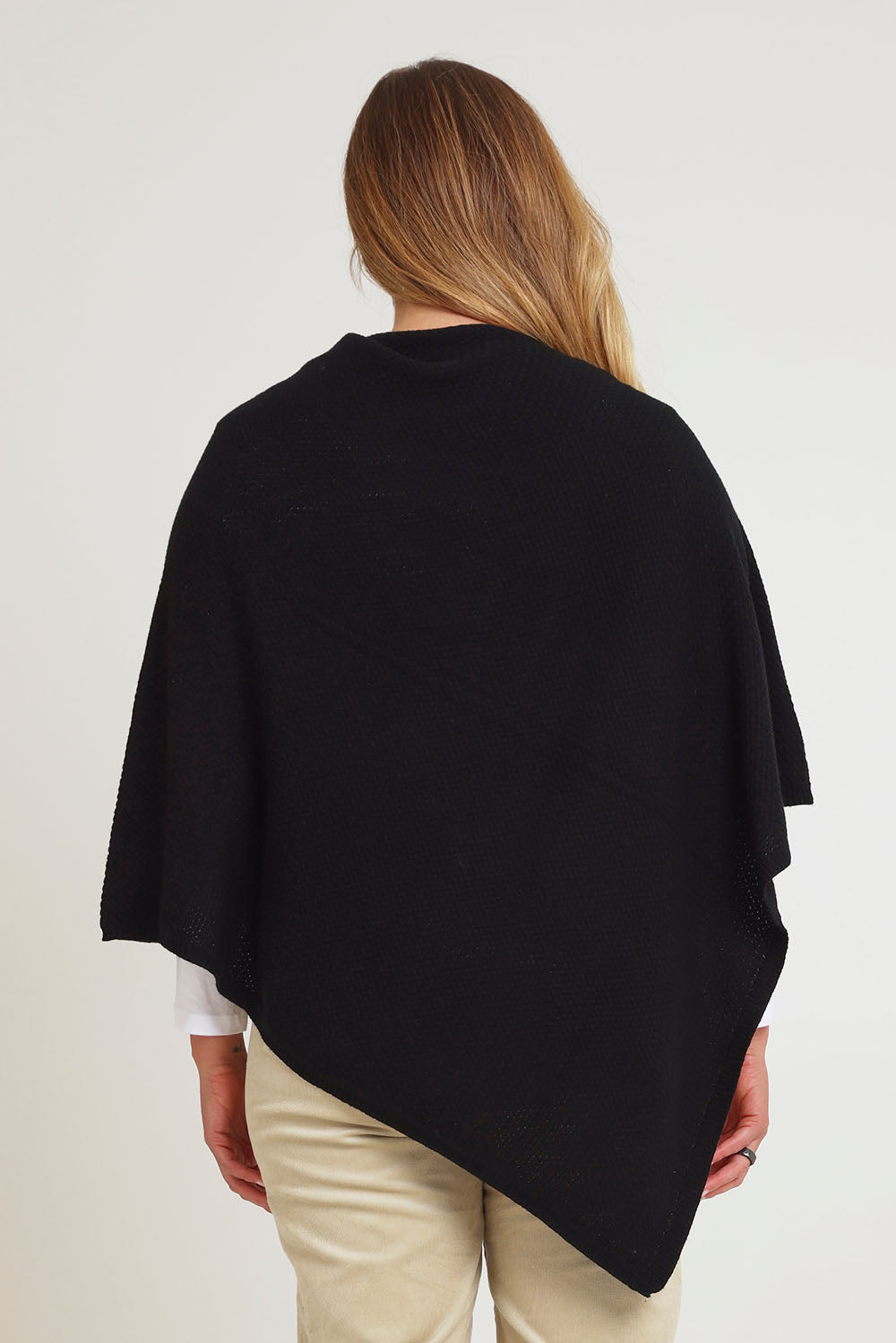 Model Chanel wearing size XL of the Cotton Cashmere Wool Poncho in colour Black (Black), from the back