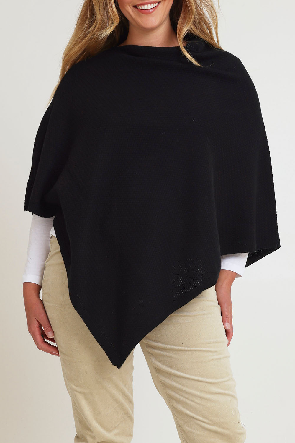Model Chanel wearing size XL of the Cotton Cashmere Wool Poncho in colour Black (Black), from the front, cropped image