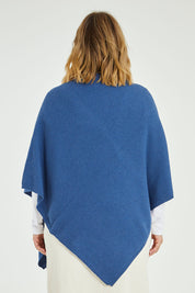 Model Jess wearing size L of the Cotton Cashmere Wool Poncho in colour Blue (Blue), from the back