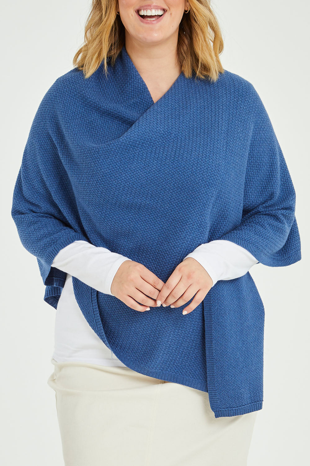 Model Jess wearing size L of the Cotton Cashmere Wool Poncho in colour Blue (Blue), from the front, cropped image