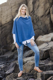 Model Kelly wearing size S of the Cotton Cashmere Wool Poncho in colour Blue (Blue), from the front, showing the whole outfit