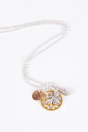 A model wearing size OneSize of the Honeybee Drop Necklace in colour Goldsilver (Metallics), from the front, showing the whole outfit