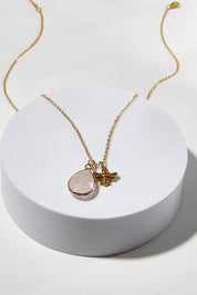 A model wearing size OneSize of the Love Rose Quartz Drop Necklace in colour Rose (Metallics), from the front, showing the whole outfit